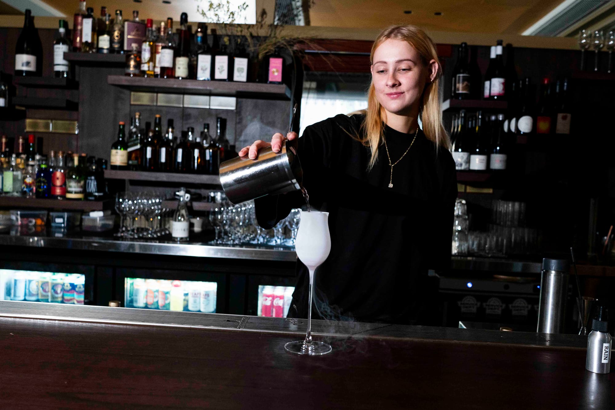Andie Bulley pouring one of her (very cold) drinks, the Chardonnay & Pineapple. Photo: Boothby